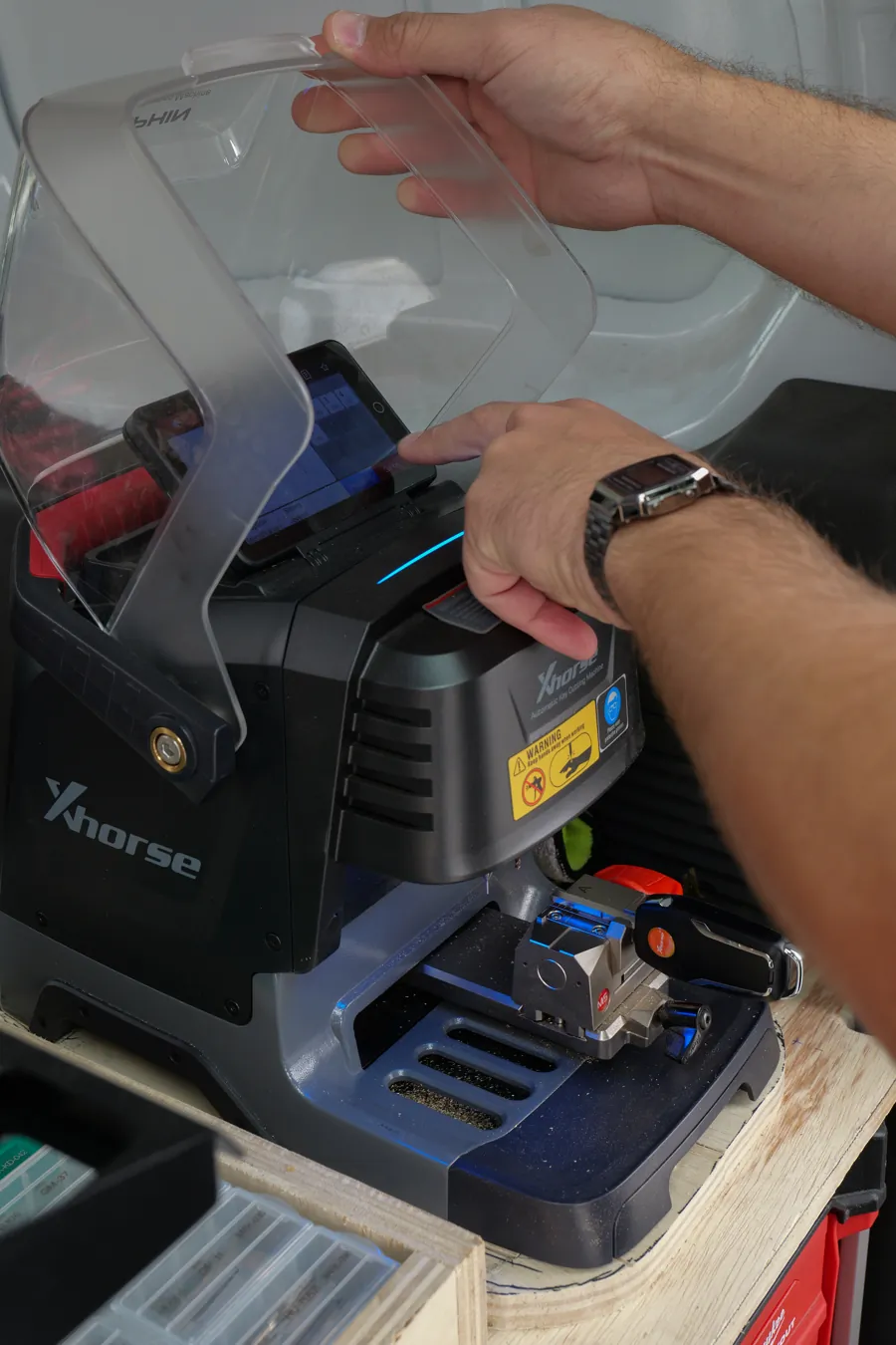 Technician opening the Xhorse automatic key cutting machine in the van, Spokane Valley, WA