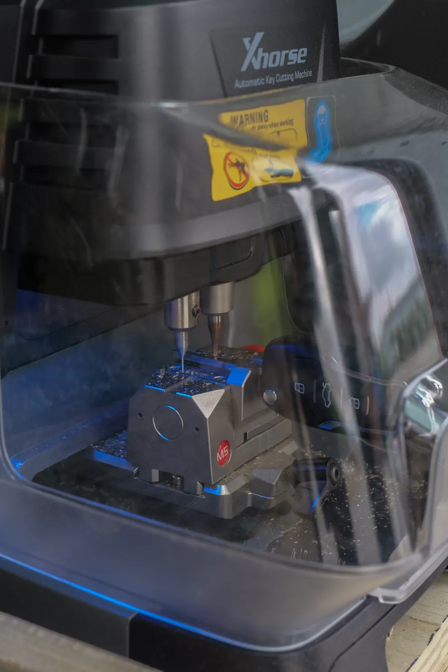 Laser key cutter milling a high-security car key under its guard, Spokane, WA